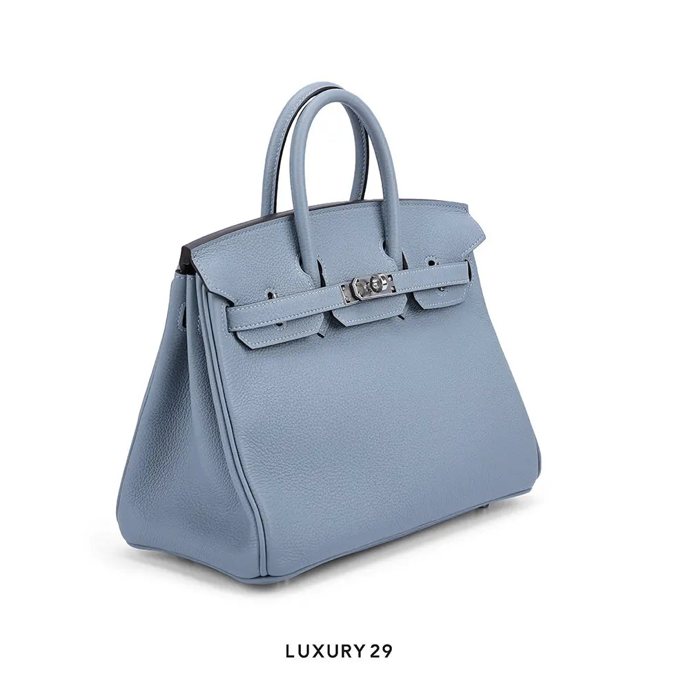 Blue handbag with a visible brand logo on a white background