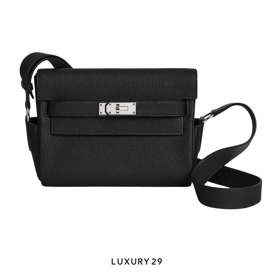 Black leather handbag with a silver clasp on a white background