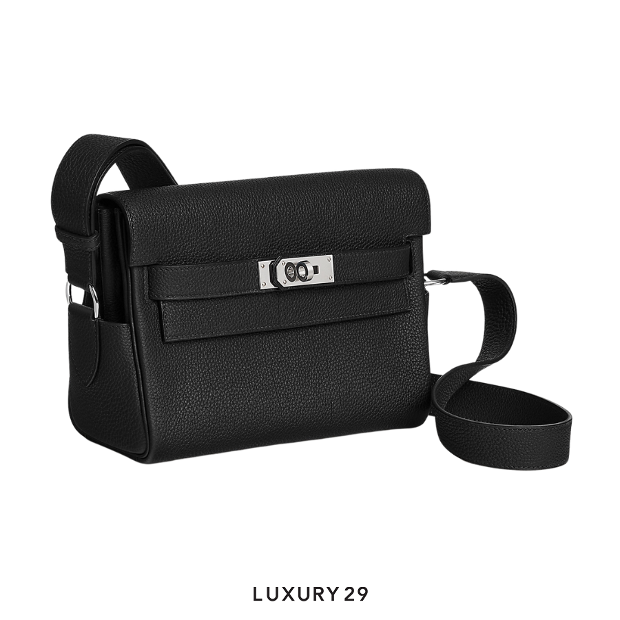 Black leather handbag with silver hardware on a white background