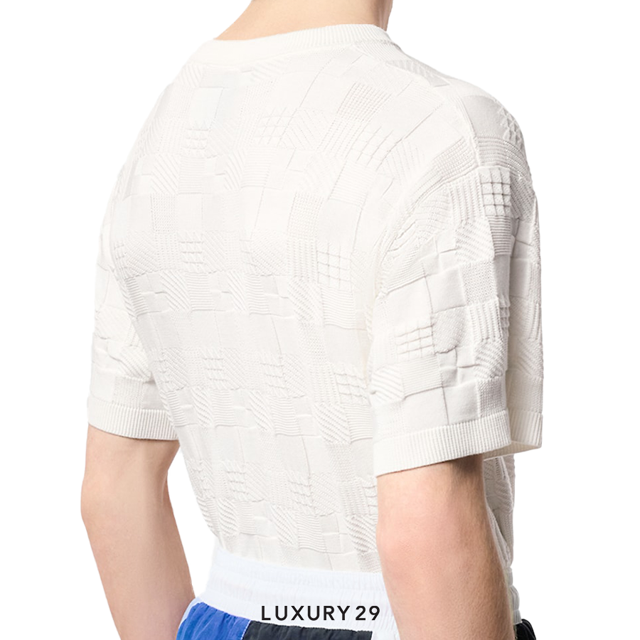 White textured short-sleeve shirt worn by a person on a white background