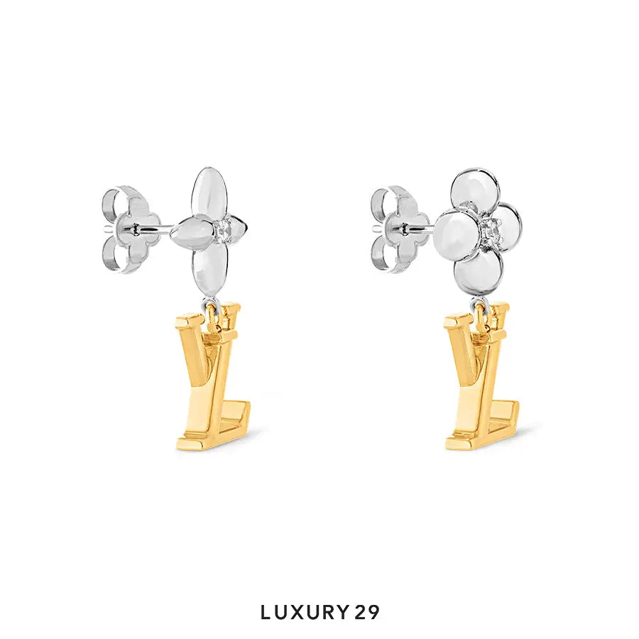Pair of silver and gold earrings on a white background with 'LUXURY 29' label.